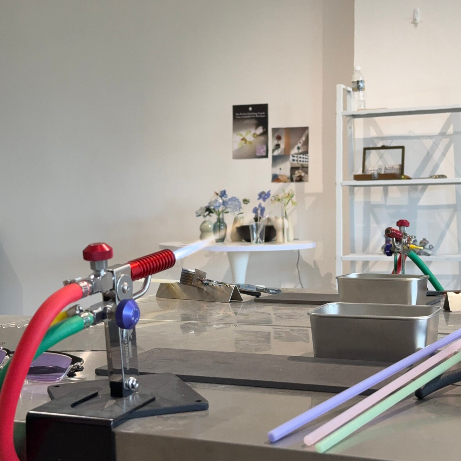 Open studio workshop with flame torch and glass rods